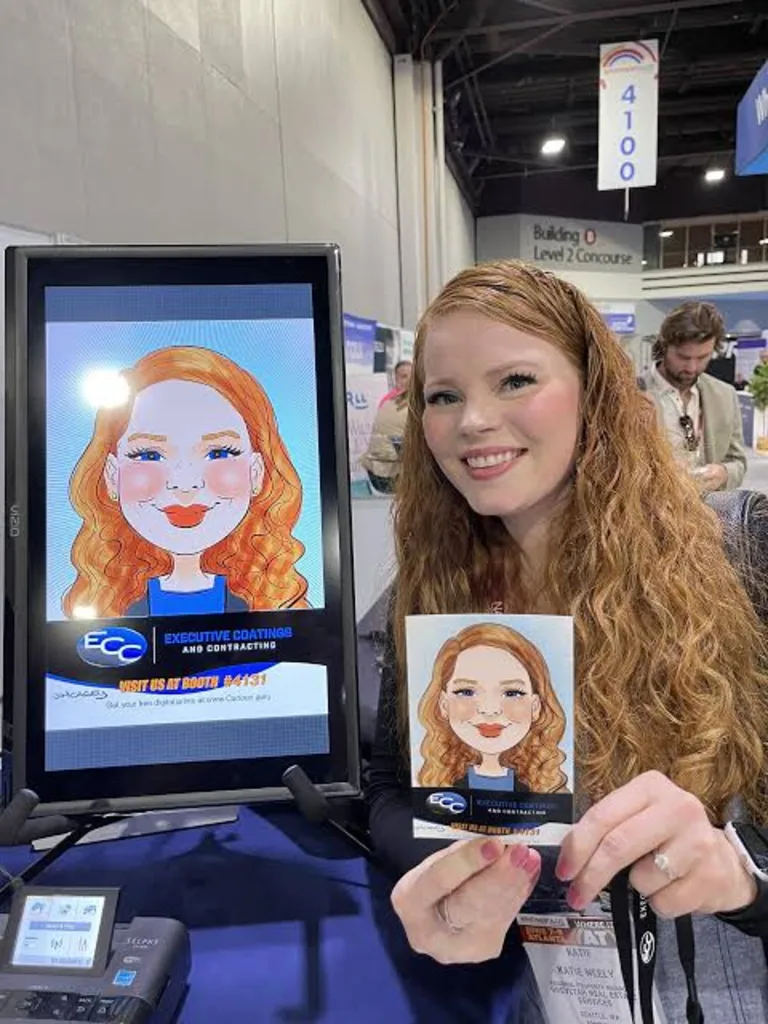Guest holding her printed digital caricature beside the artist's screen at a trade show booth