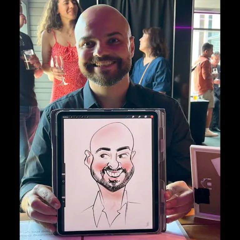 Guest showing his live digital caricature on a tablet at an evening event